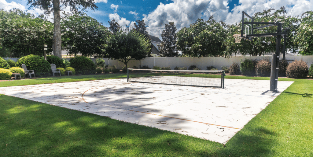 Finished backyard pickleball court with geocell surface and net in residential setting